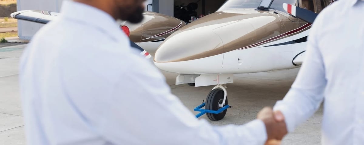 Business partners completing an aircraft purchase agreement at a private aviation terminal