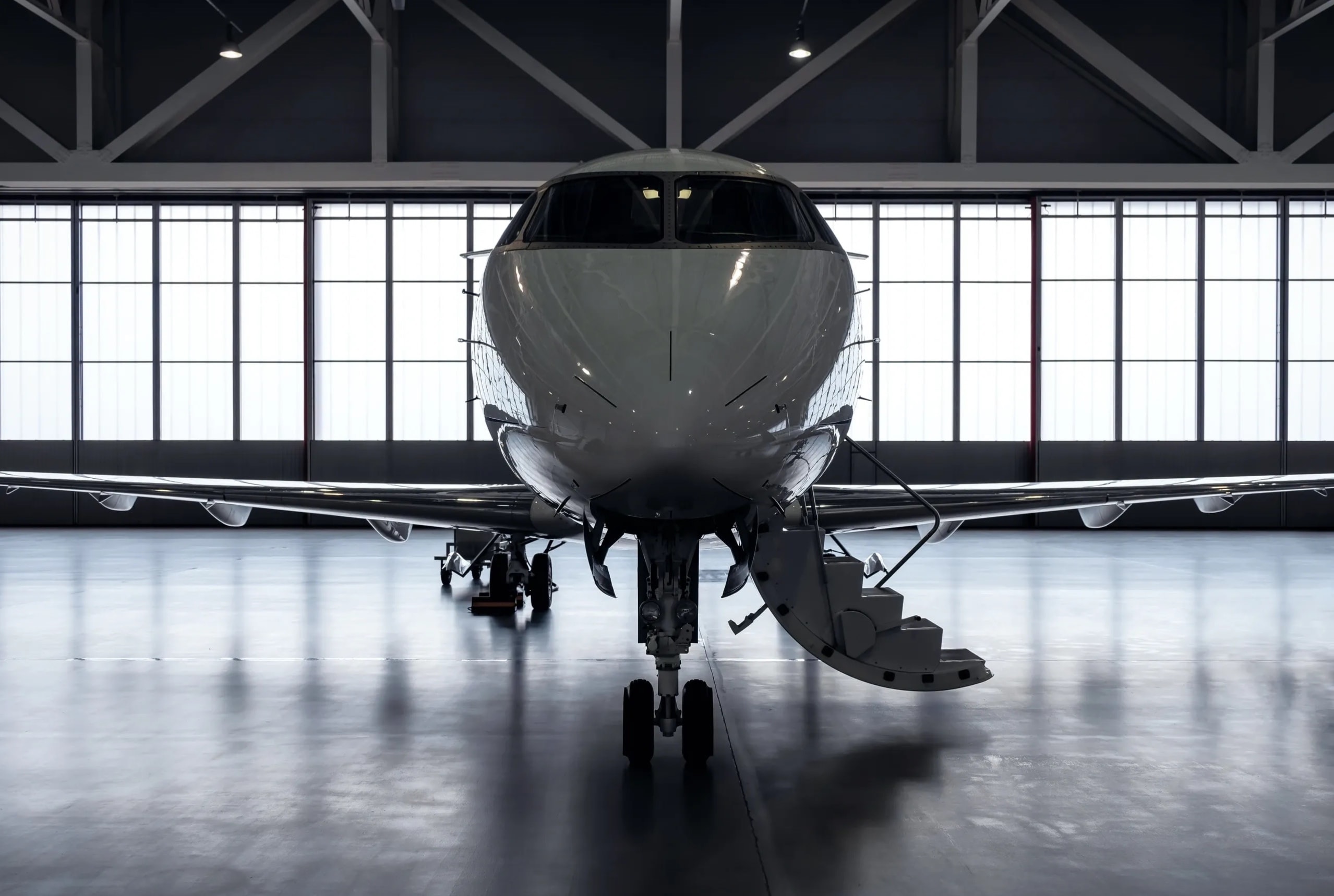 A private jet inside an aviation hangar, representing the off-market aircraft acquisition process